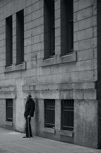 black-and-white man standing near a wall seattle